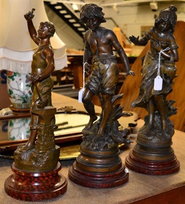 Lot 1015 - Three French spelter figures, comprising a pair after Moreau, another of a blacksmith, plinth bases