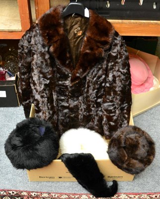 Lot 1020 - A textured dark mink fur coat, mink hat, two faux fur hats in black and white, black mink...