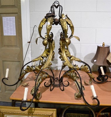 Lot 1056 - A wrought iron and parcel gilt metal foliate scrollwork six light electrolier, 99cm high