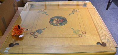 Lot 1065 - An Indian Carrom board game, with a glass top and game counters