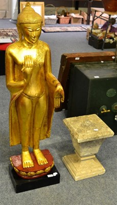 Lot 1084 - A Thai giltwood buddha, on integral plinth, 127cm in height together with a stone composite...