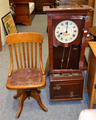 Lot 1111 - A time recording clock and a early 20th century swivel oak office chair