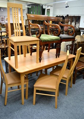 Lot 1115 - A modern dining table and six matching chairs