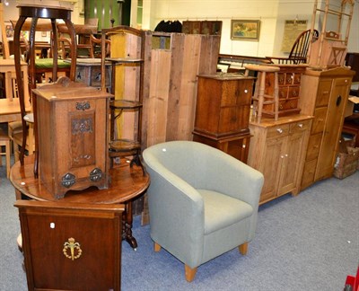 Lot 1125 - A group of furniture comprising an oak cupboard, oak pot cupboard, cake stand, two plant stands, an