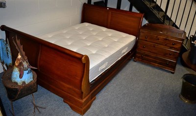 Lot 1127 - A mahogany sleigh bed together with a modern three height chest of drawers (2)