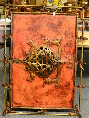 Lot 1139 - A Nordic influence leather panel screen, gilt metal frame, pierced and embossed central...