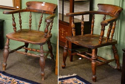 Lot 1248 - An oak captain's chair together with an elm and oak captain's chair (2)