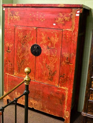 Lot 1258 - A Chinese red lacquered wedding cabinet, 19th century, gilt embellished, twin doors, metal lock...