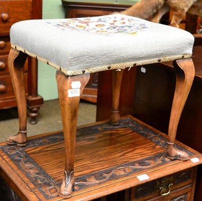 Lot 1273 - An upholstered stool with cabriole legs, boot form feet and a floral woolwork seat