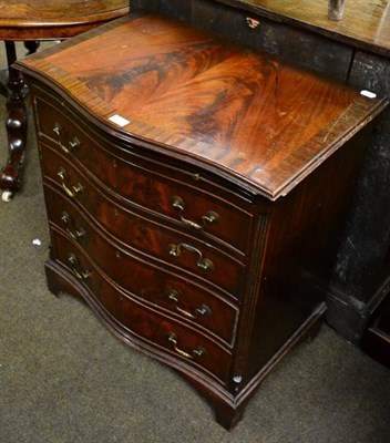 Lot 1287 - A reproduction serpentine fronted mahogany veneered chest of drawers fitted with a dressing slide