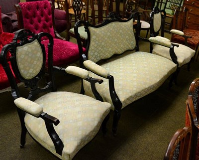 Lot 1307 - An Victorian ebonised three piece parlour suite comprising a two seater settee and two armchairs