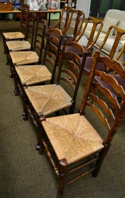 Lot 1317 - Six rush seated ladder back dining chairs