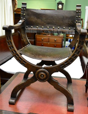 Lot 1326 - An early 20th century oak Savonarola chair