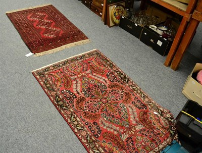 Lot 1358 - Two red ground floral and geometric design rugs (2)