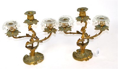 Lot 188 - A pair of ormolu three light candelabra of rococo design, one stamped ";384B"; to underside