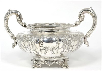 Lot 189 - A William IV Irish silver twin handled sugar bowl, James Moore, Dublin 1837, chased with a band...