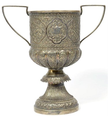 Lot 190 - An Indian white metal twin handled cup, script marks, possibly Kutch, chased with scrolling foliage