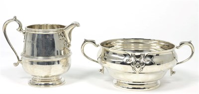 Lot 206 - A silver cream jug, Adie Bros, Birmingham 1932, in the George II style with reeded girdle; and...