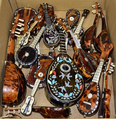 Lot 212 - A group of decorative tortoiseshell models of guitars