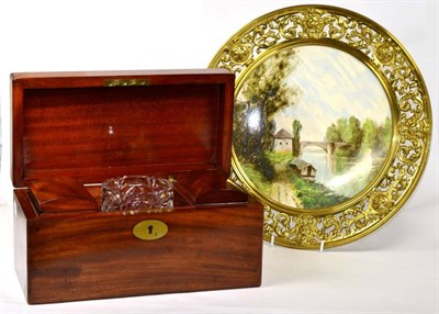 Lot 246 - A 19th century mahogany tea caddy together with a painted charger in brass mount (2)