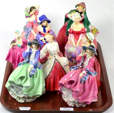 Lot 253 - Royal Doulton figures to include Top O' The Hill in two colour ways; A Victorian Lady; Maytime;...