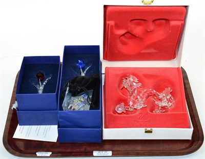 Lot 275 - A Swarovski crystal model of a dragon, boxed; and two flowers