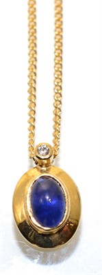 Lot 333 - A sapphire and diamond pendant, on 9 carat gold chain, an oval cabochon sapphire in a rubbed...