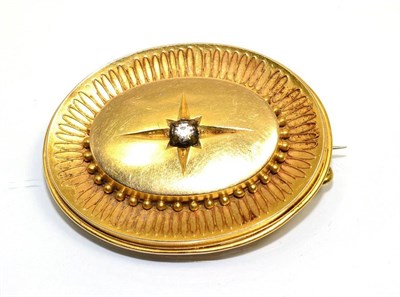 Lot 345 - A Victorian Etruscan revival brooch, with a central star set paste stone, to an oval dome with...