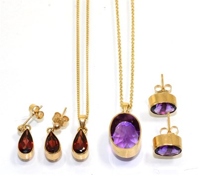 Lot 353 - A 9 carat gold garnet pendant and earring suite, pear cut garnets in rubbed over settings, the...