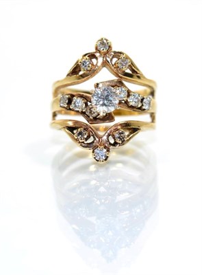 Lot 360 - A diamond ring, a round brilliant cut diamond in a claw setting, to a triple band shank set...