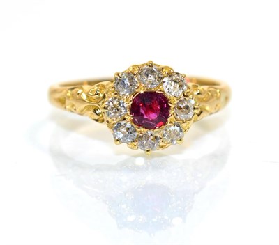 Lot 374 - A ruby and diamond cluster ring, a round cut ruby within a border of old to diamonds, to scroll...