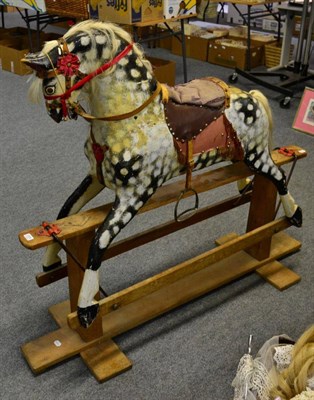 Lot 1034 - An F H Ayers style painted wooden rocking horse on trestle base