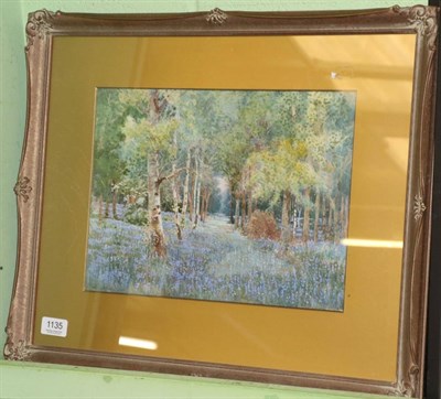 Lot 1135 - A watercolour signed Will Outhwaite depicting a woodland in bloom with bluebells in burnham...