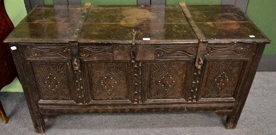 Lot 1182 - An iron bound oak coffer, with carved four panel front