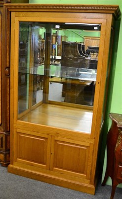 Lot 1185 - A good quality modern oak display cabinet, with single glazed door, fitted for electricity