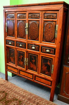 Lot 1190 - A 20th century part ebonised Chinese softwood cabinet fitted with an arrangement of cupboard...