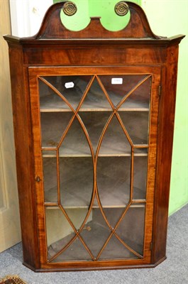 Lot 1191 - An early 19th century glazed mahogany corner cabinet, with astragal glazed door