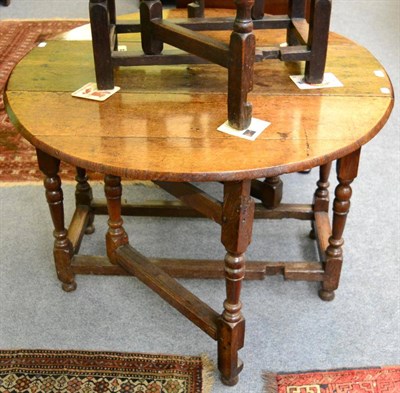 Lot 1193 - An 18th century oak double drawer drop leaf table