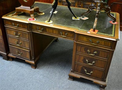 Lot 1199 - A reproduction twin pedestal desk with leather inset top