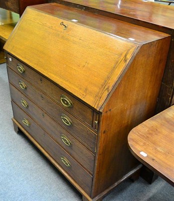 Lot 1200 - An oak bureau on bracket feet