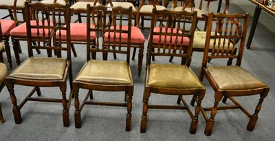 Lot 1230 - A set of four oak dining chairs with leather drop in seats