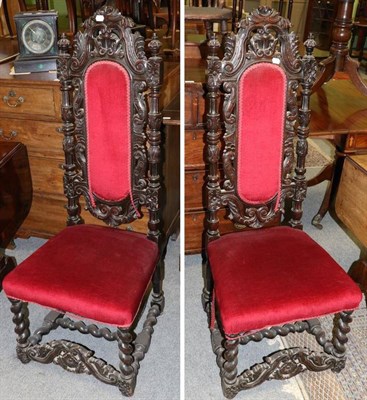 Lot 1241 - Pair of Victorian carved oak high backed hall chairs