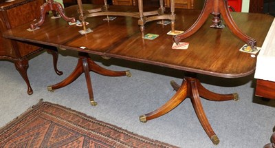 Lot 1266 - Mahogany twin-pillar dining table, fitted with an additional leaf