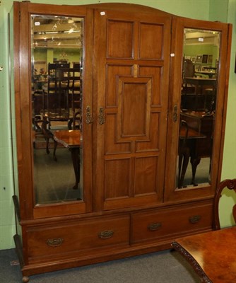 Lot 1273 - An oak mirror fronted triple wardrobe