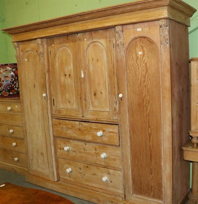 Lot 1274 - Victorian pine wardrobe with twin cupboard doors above three graduated drawers, flanked by a...