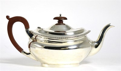 Lot 190 - A silver teapot, Birmingham 1928, oval with gadroon rim, 28cm long handle to spout, 19.5ozt