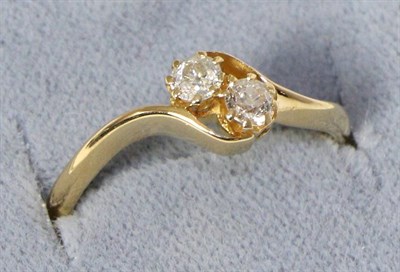 Lot 229 - An 18 carat gold old cut diamond three stone ring, with bypass shoulders, total estimated...