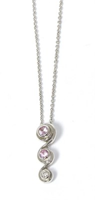 Lot 235 - A 9 carat white gold pink sapphire and diamond pendant on chain, drop length 2cm, chain length...