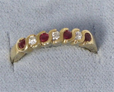 Lot 242 - A 9 carat gold ruby and diamond half hoop ring, total estimated diamond weight 0.15 carat...