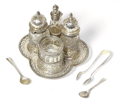 Lot 254 - A Victorian silver and glass four piece cruet set, by George Fox. London, 1881, with pierced quatre